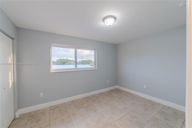 1955 NW 5th Pl Unit 13, Miami, FL 33136 - empty room featuring light tile patterned floors and baseboards