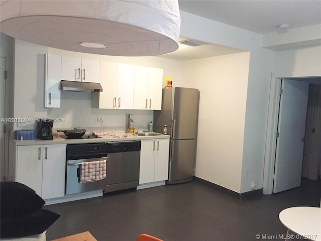 kitchen with light countertops, appliances with stainless steel finishes, white cabinetry, and under cabinet range hood