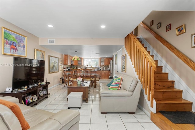 living room featuring recessed lighting, light tile patterned floors, baseboards, and stairs