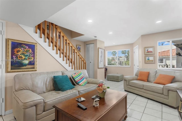 living room with light tile patterned floors, stairway, and recessed lighting