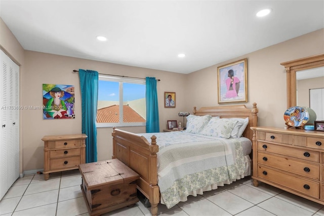 bedroom with baseboards, a closet, light tile patterned flooring, and recessed lighting