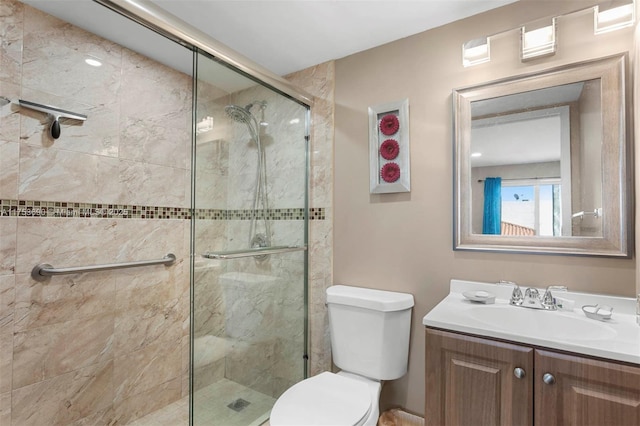 full bath featuring vanity, a shower stall, and toilet