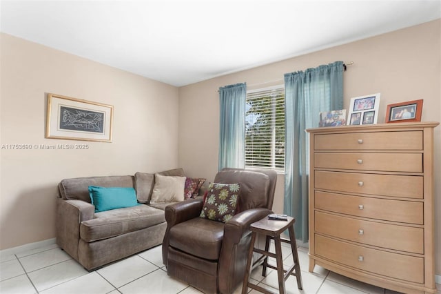 living room with baseboards and light tile patterned floors