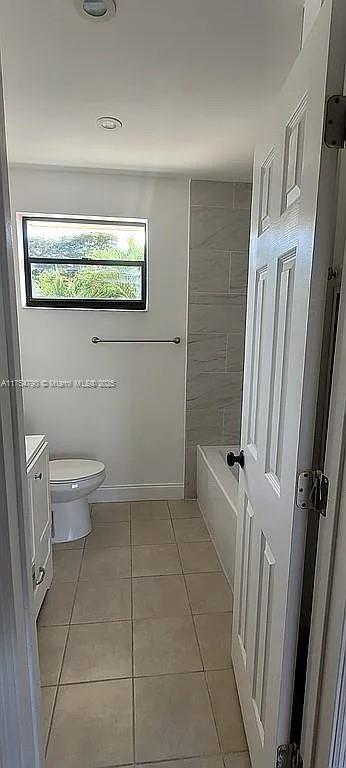 bathroom with vanity, toilet, and tile patterned floors