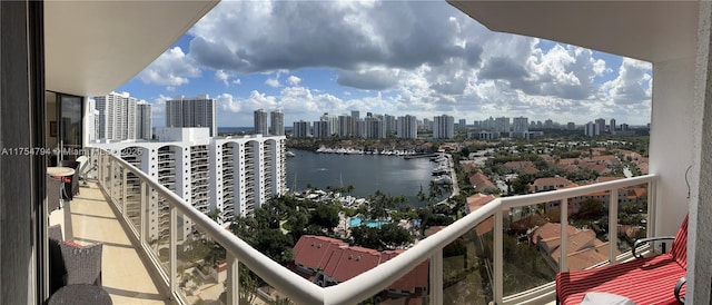 balcony featuring a view of city and a water view