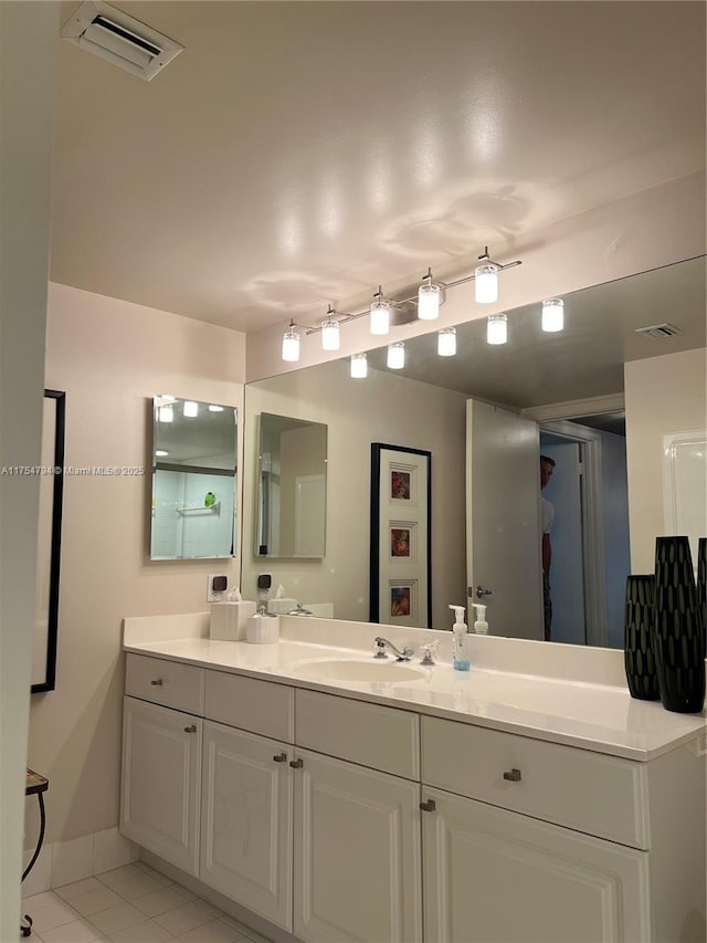 bathroom featuring vanity, visible vents, and tile patterned flooring