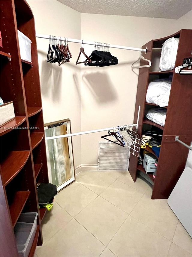 spacious closet featuring tile patterned floors