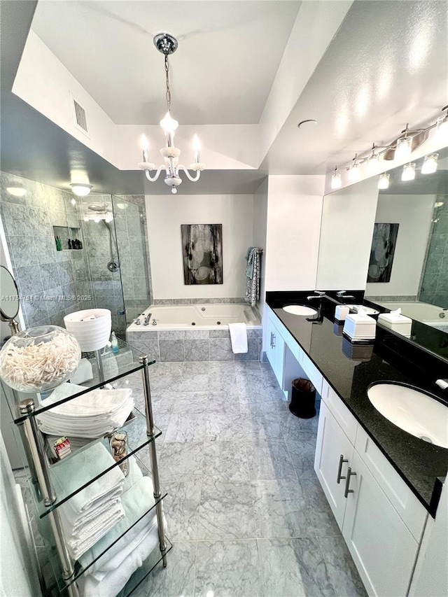 full bathroom featuring visible vents, a stall shower, a whirlpool tub, and a sink