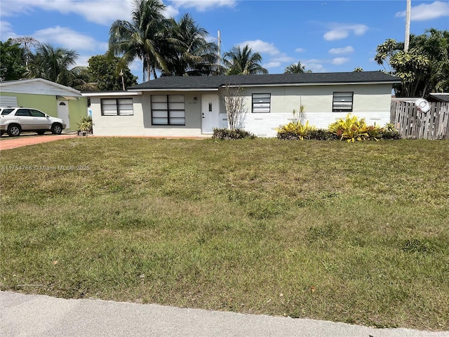 ranch-style home with a front lawn and stucco siding