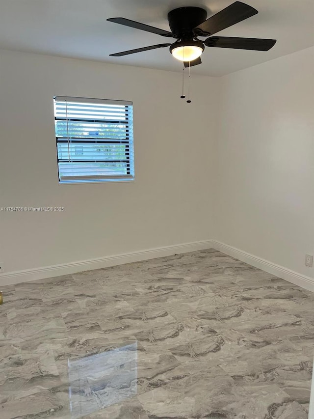 empty room featuring baseboards