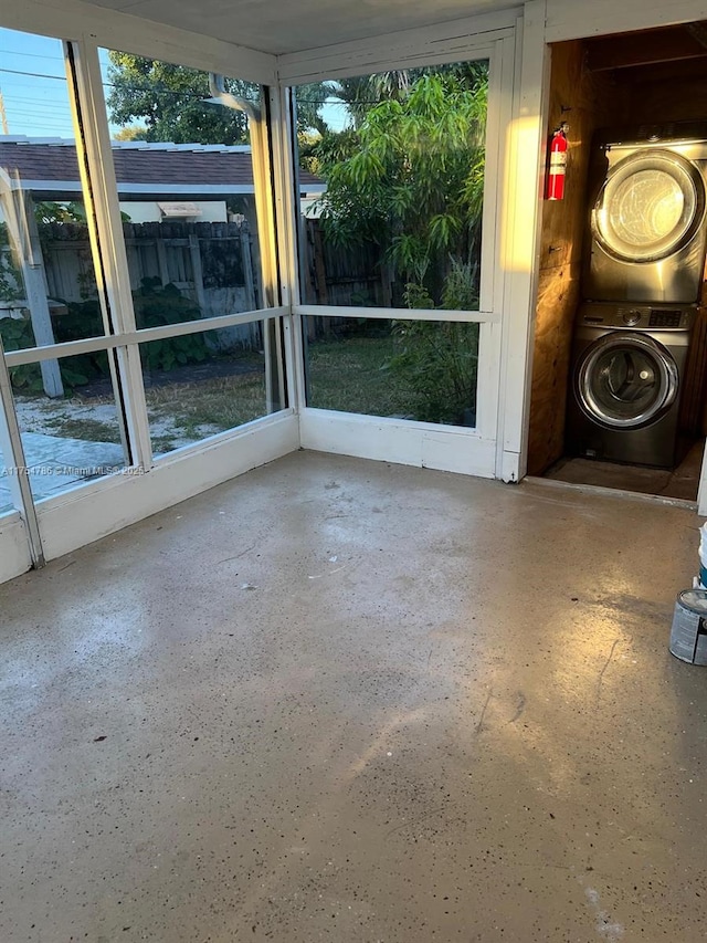 unfurnished sunroom with washer / dryer and a healthy amount of sunlight