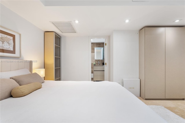 bedroom with recessed lighting, visible vents, and ensuite bathroom