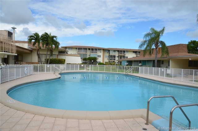 community pool featuring fence