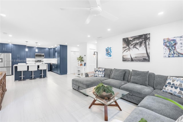 living room with a ceiling fan and recessed lighting