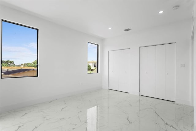 3430 SW 2nd St, Miami, FL 33135 - unfurnished bedroom with baseboards, visible vents, marble finish floor, two closets, and recessed lighting