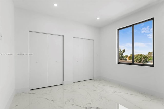 3430 SW 2nd St, Miami, FL 33135 - unfurnished bedroom with recessed lighting, marble finish floor, baseboards, and two closets