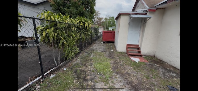 view of yard with entry steps and fence