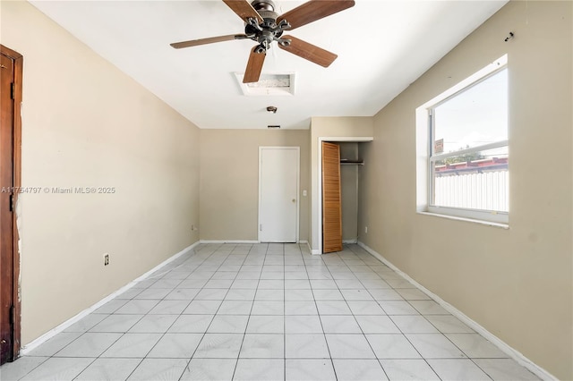 empty room with a ceiling fan and baseboards