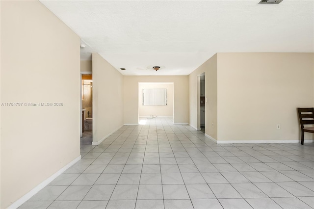 spare room featuring visible vents and baseboards