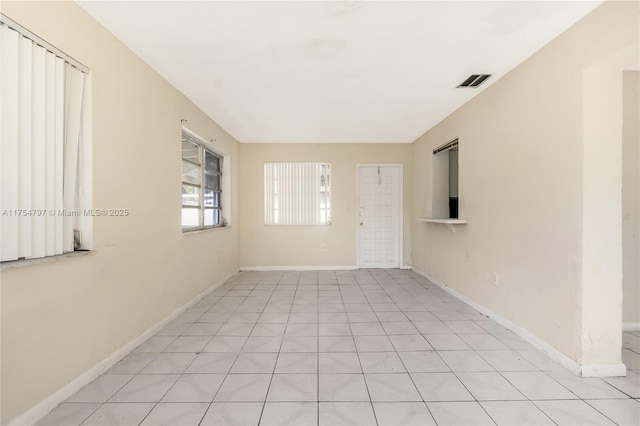 unfurnished room featuring visible vents and baseboards