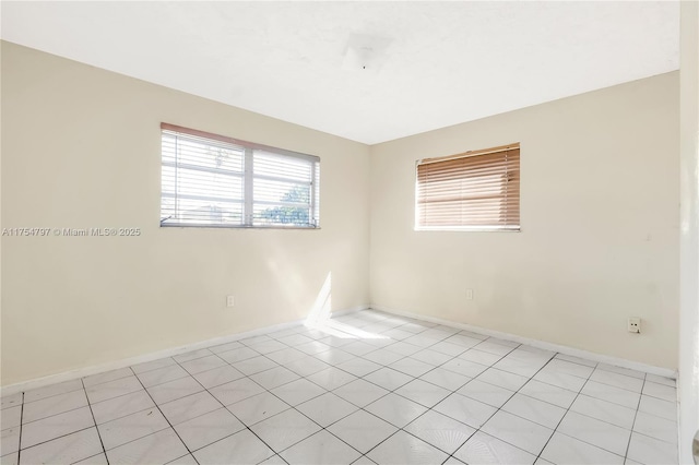 spare room featuring baseboards