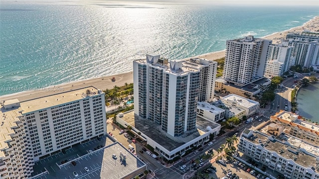 aerial view featuring a water view, a view of city, and a view of the beach