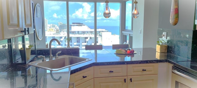 kitchen with wall oven, a wealth of natural light, white cabinets, and a sink