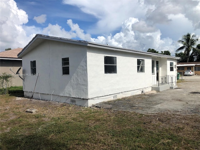 view of side of home featuring crawl space