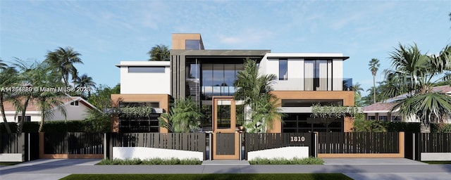 contemporary house with a fenced front yard, a gate, a balcony, and stucco siding