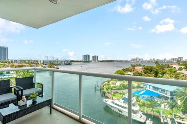 balcony with a water view and a city view