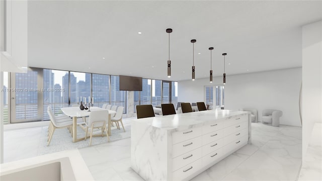 kitchen featuring marble finish floor, white cabinetry, and modern cabinets