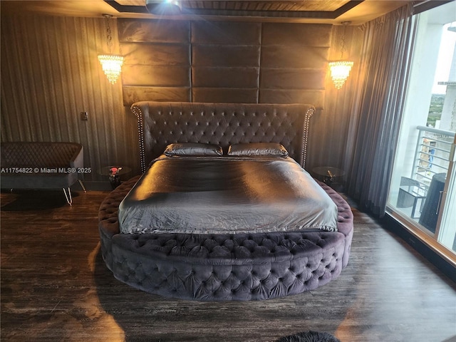 bedroom featuring wood walls and wood finished floors