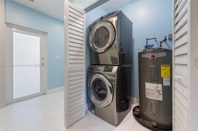 laundry room featuring water heater, laundry area, tile patterned flooring, and stacked washer / drying machine