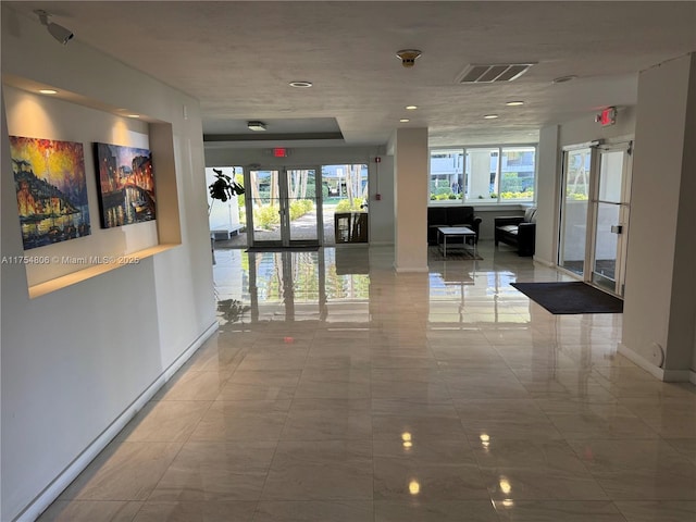 555 Crandon Blvd Unit 32, Key Biscayne, FL 33149 - corridor with baseboards, french doors, and marble look tiles