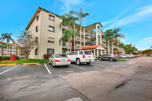 view of building exterior featuring uncovered parking