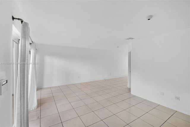 unfurnished room featuring visible vents and baseboards