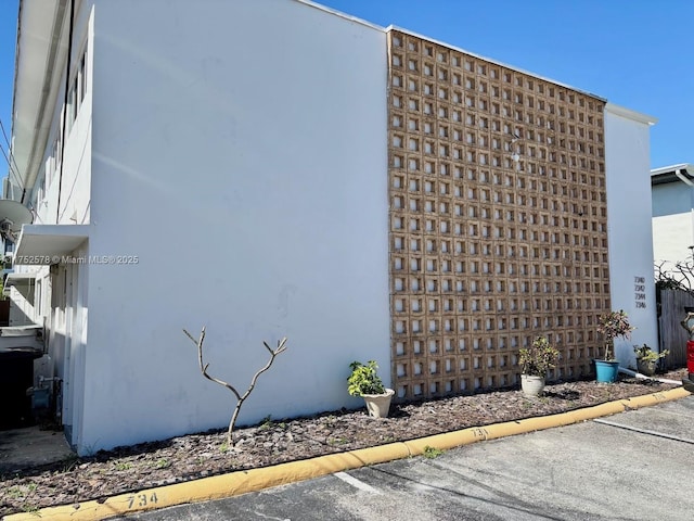 view of building exterior with uncovered parking