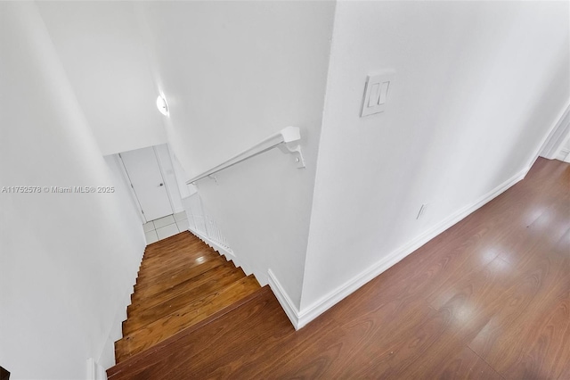 stairs with baseboards and wood finished floors