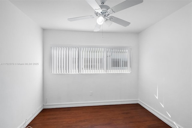 empty room featuring wood finished floors, a ceiling fan, and baseboards