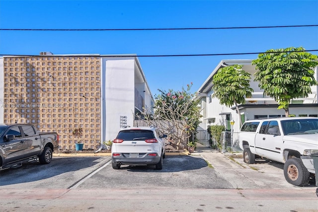 exterior space with uncovered parking and fence