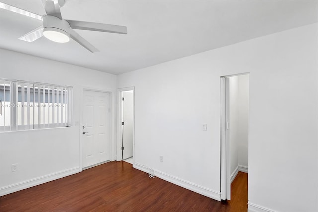 empty room with ceiling fan, baseboards, and wood finished floors