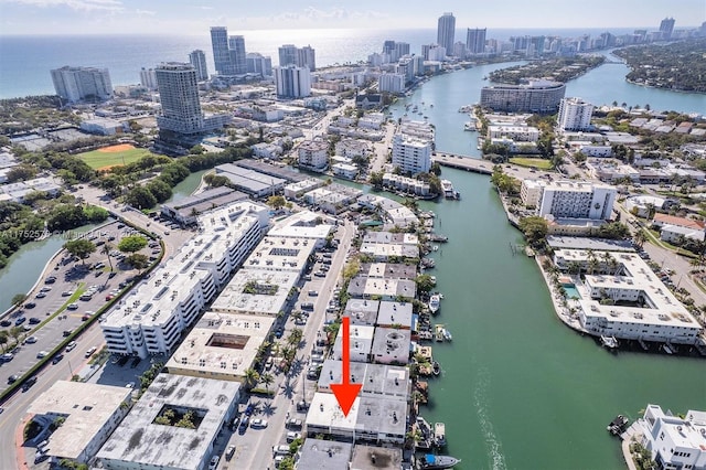 drone / aerial view featuring a view of city and a water view