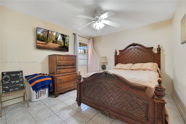 bedroom with a ceiling fan, light tile patterned flooring, and baseboards