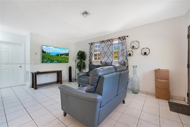 living room featuring light tile patterned floors and visible vents