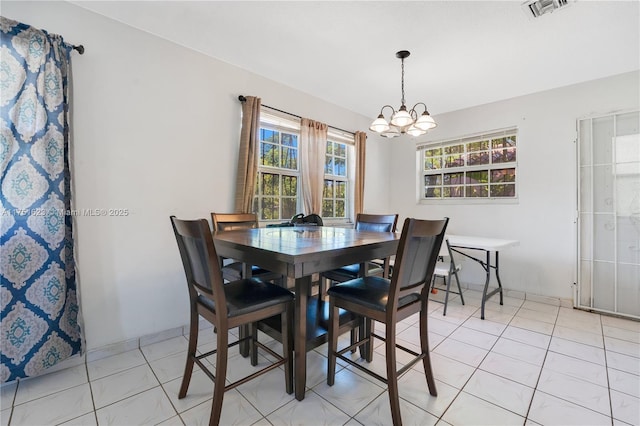 dining room featuring visible vents, an inviting chandelier, and light tile patterned flooring