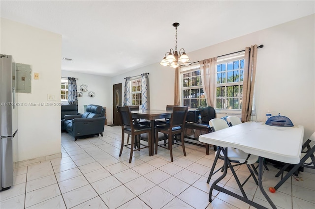 dining area with a chandelier, light tile patterned floors, and visible vents