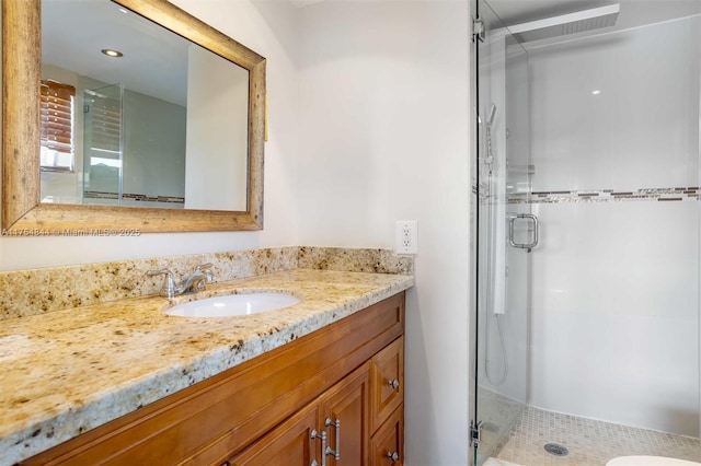 full bath featuring a shower stall and vanity