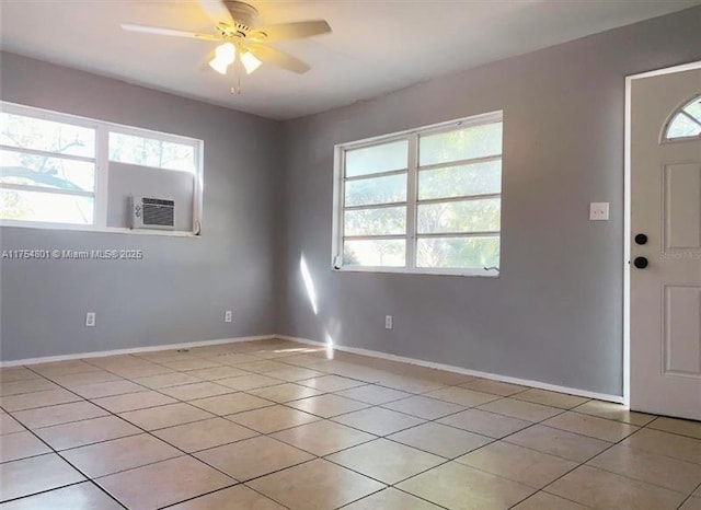 entryway featuring light tile patterned floors, baseboards, a wealth of natural light, and a ceiling fan