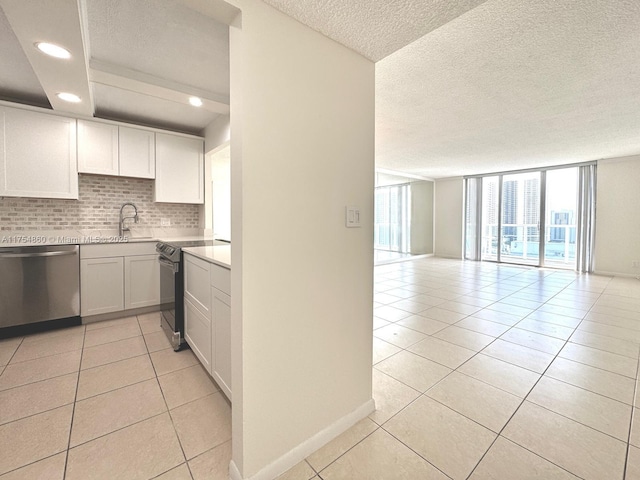 kitchen featuring decorative backsplash, electric range oven, open floor plan, a sink, and dishwasher