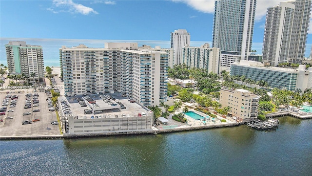 drone / aerial view featuring a view of city and a water view